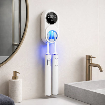UV toothbrush sterilizer mounted on bathroom wall next to sink in a modern bathroom.